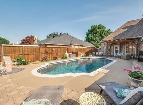 Sparkling pool with comfy loungers, outdoor seating, and a private fenced backdrop. Perfect for relaxing or soaking up the Texas sun.