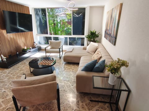 Spacious living area, television, couch, chairs
