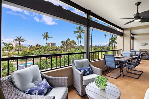 Settle into your private lanai where tropical breezes and lush palm tree views set the scene. Comfortable seating and a dining area make it perfect for morning coffee, al fresco meals, or evening cocktails under the ceiling fan.