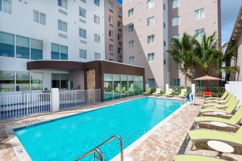 Relax by the poolside with comfortable lounge chairs, ideal for soaking up the sun.