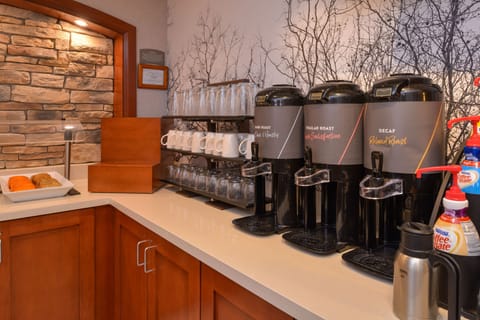 Breakfast station with a selection of beverages and treats.