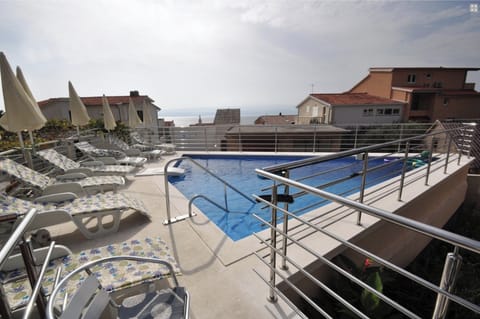 Pool with sun loungers & sitting area