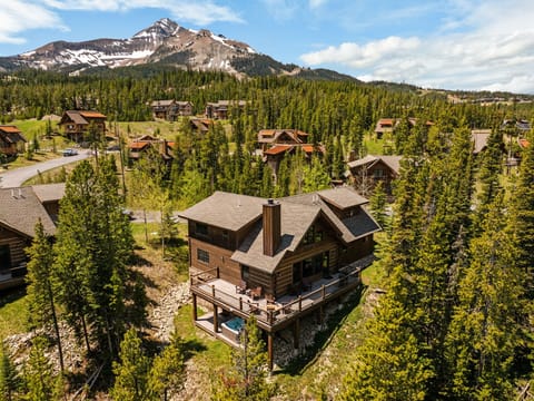 Nestled in a mountain community surrounded by towering evergreens, this private vacation retreat features stunning alpine views and a secluded outdoor hot tub for ultimate relaxation.