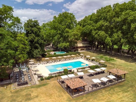 The outdoor pool sits at the centre of a 7-hectare landscaped park, where sun loungers and shaded terraces invite guests to unwind between explorations of the Luberon.