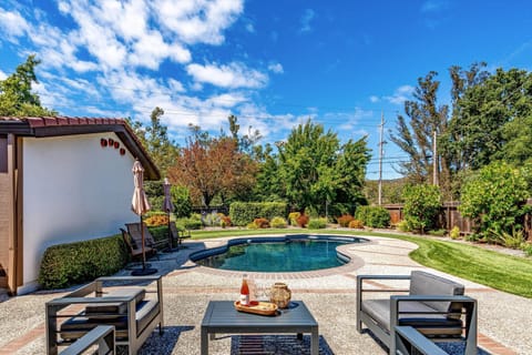 Soak up the sun on your private pool deck, surrounded by lush landscaping and open skies. Modern lounge seating awaits your afternoon escape—perfect for poolside relaxation.