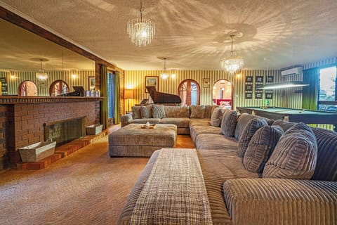 Unwind in the main living area, where generous seating, garden outlooks and character-filled interiors create an inviting place to reconnect after a day exploring the waterfront.