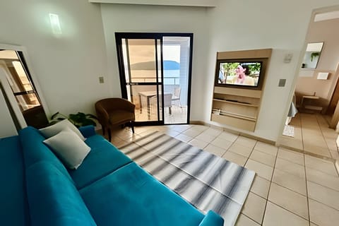 Deluxe Apartment, Balcony, Beach View | Living area | TV