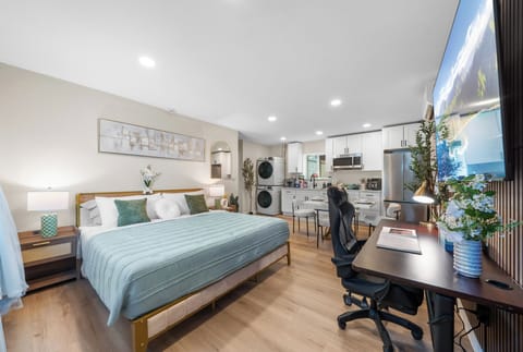 Bright and inviting bedroom with a comfortable bed and dedicated workspace.