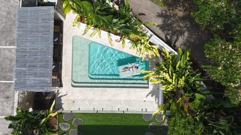 Cool off in the private pool surrounded by lush tropical gardens, creating a peaceful setting for sunny afternoons and refreshing swims.