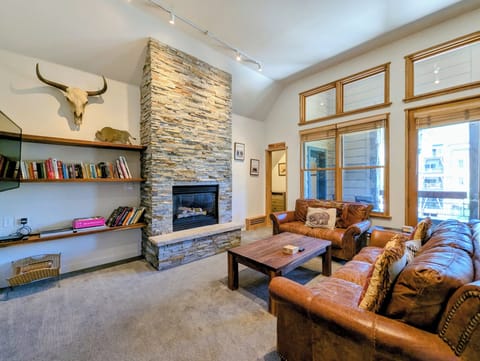 Picture yourself unwinding here after a mountain day—sink into soft leather sofas by your stone fireplace, browsing books from your personal shelf, surrounded by comfort.