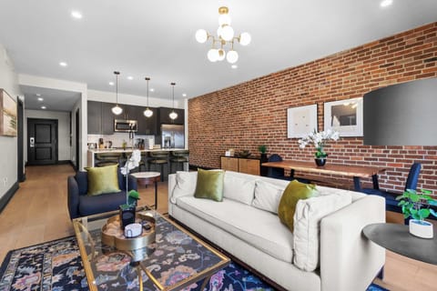 Relax in the living area with a smart TV, stylish seating, and a sleeper sofa for extra guests. Perfect for families or group stays in New Orleans, this inviting space is ideal for movie nights or recharging after a day in the city.