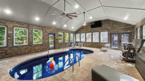 Spacious indoor pool with vaulted ceilings, lounge seating, and plenty of natural light.