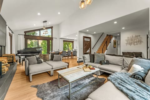 Living room: Wood-burning fireplace, smart TV, Sonos sound system, piano, main floor