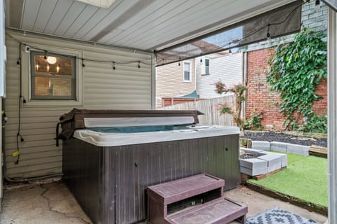 Covered patio hot tub with cozy string lights and private outdoor space
