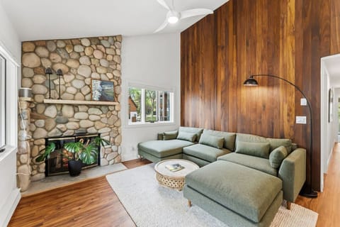 Mid Century living room with comfy seating and vaulted ceilings