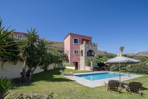 This image captures the exterior of a beautiful, multi-level Mediterranean vacation villa.