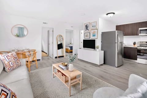 Unwind in the bright living room with comfortable seating and a Smart TV for your entertainment.