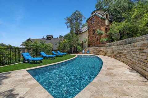 Pool and stone castle terrace over the West Austin treetops