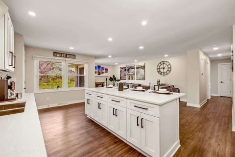 This bright, open kitchen features a spacious island ideal for group meals, casual snacks, or late-night laughs that stretch well into the evening.