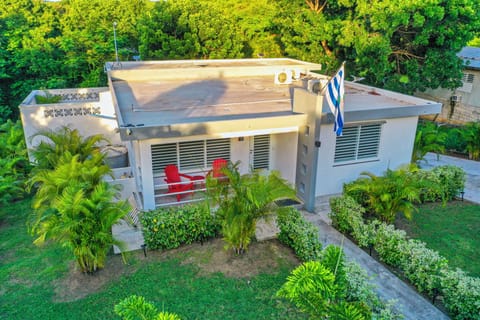 Tropical villa with lush gardens, private porch, and inviting outdoor seating