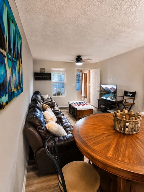 Inviting living and dining area with comfortable seating, and smart TV. 
