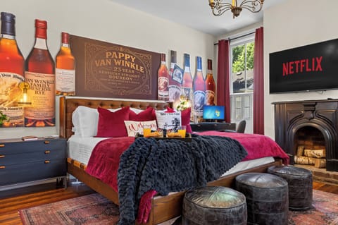 Check into the Pappy Van Winkle Room, featuring a king bed draped in burgundy, luxury linens and décor inspired by bourbon's most coveted name.