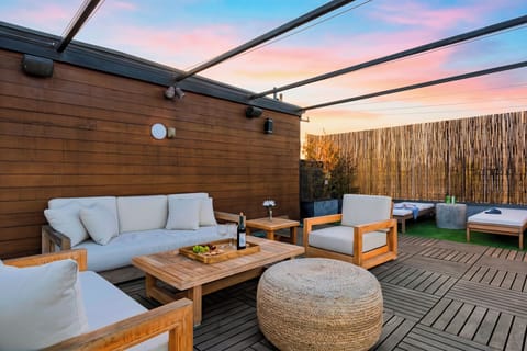 Rooftop lounge with plush sofa seating.