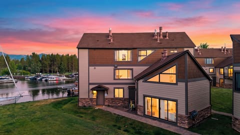 Marina-side retreat at sunset with glowing interiors, water views, and boat docks just steps away.