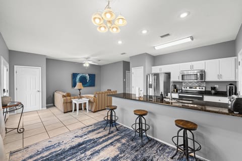 Step into your open-plan retreat where sleek kitchen meets relaxed living space. Modern stainless appliances, granite counters, and cozy seating invite you to cook, gather, and unwind.