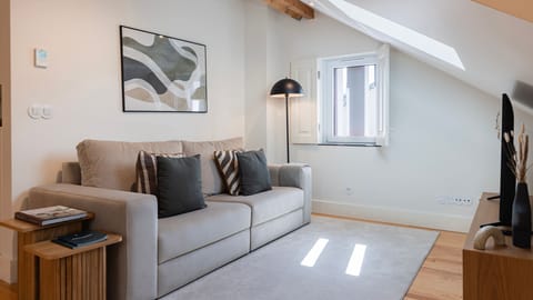 Relax in this bright and stylish open-plan living space, where modern comfort meets charming attic architecture for the perfect getaway. #LivingRoom #ModernStay #CozyEscape #HomeAwayFromHome #Portugal #PT #Sintra