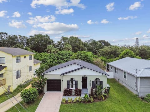 our peaceful escape begins here. This impeccably maintained ranch-style home boasts a unique, inviting entrance with a dramatic arched doorway and matching front windows.