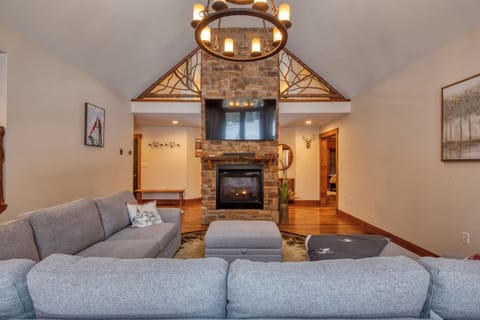 Vaulted ceilings and Adirondack-inspired finishes create a warm and inviting gathering space.