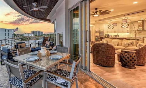 Evenings on the covered balcony are even better with al fresco dining, comfortable seating, and glowing Gulf sunsets.