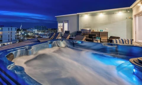 Your private rooftop retreat comes alive after sunset with a bubbling hot tub and unforgettable evening views.