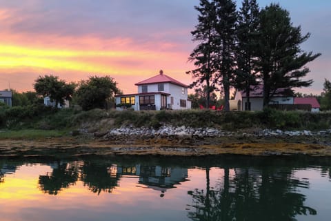 Step outside at golden hour and watch the tidal cove turn into a mirror — this is the view you will come home to every evening.