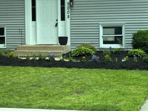 Welcoming entry with fresh landscaping and great curb appeal