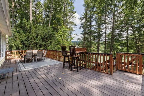 Spacious forest-view deck with outdoor dining and peaceful seating