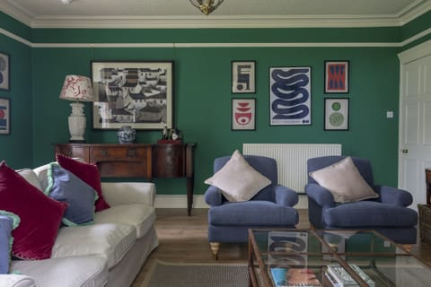 Sunderland Farmhouse - sitting room with original artwork and comfortable seating for eight guests
