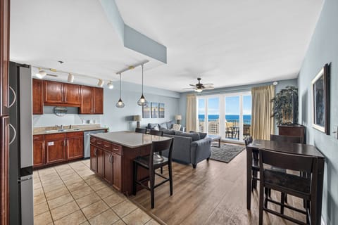 Wake up to stunning ocean views from your open-concept living space. Bright blue waters frame your private balcony, while rich wood finishes and modern lighting create a welcoming coastal retreat for your getaway.