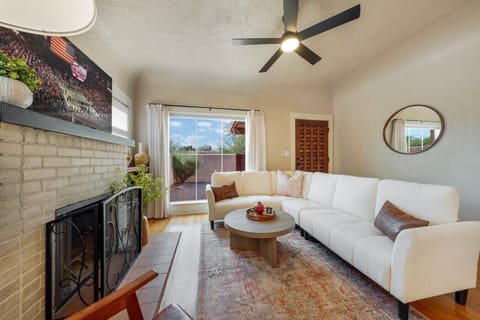 Cozy living room with comfortable seating, smart TV, decorative fireplace (nonfunctional) and views of the lovely front yard