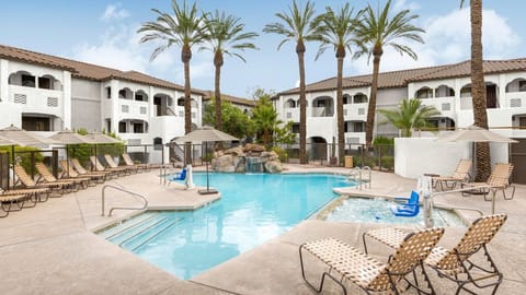 Plunge into relaxation by the pool, surrounded by swaying palms and inviting lounge chairs.
