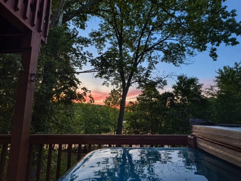 Private hot tub on the lower deck at sunset with seasonal Nolin Lake views.