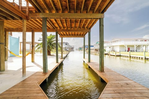 Covered boat dock with direct canal access for boating, fishing, and crabbing.
