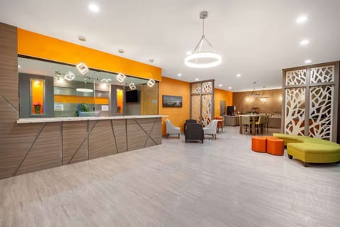 Spacious front desk and lounge with warm colors and seating
