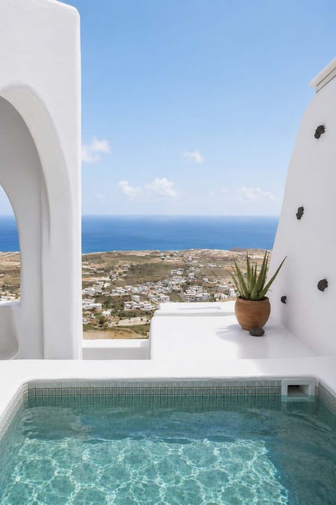 Apollonas - Private heated jacuzzi with sea views and classic whitewashed Santorini style.