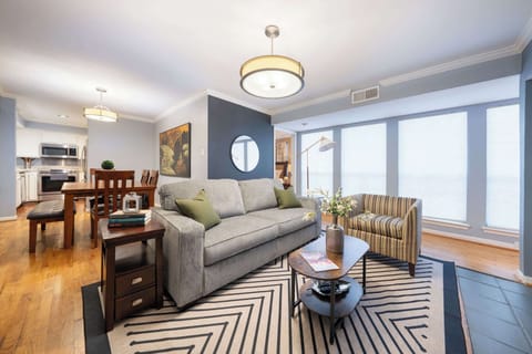Spacious living area with modern decor and ample seating, perfect for relaxation and gatherings.