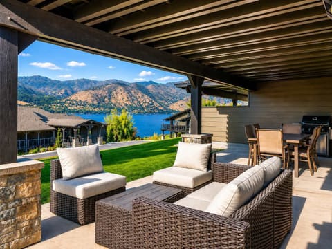 Relax on a shaded outdoor patio featuring comfortable wicker lounge furniture and beautiful lakeside dining areas.