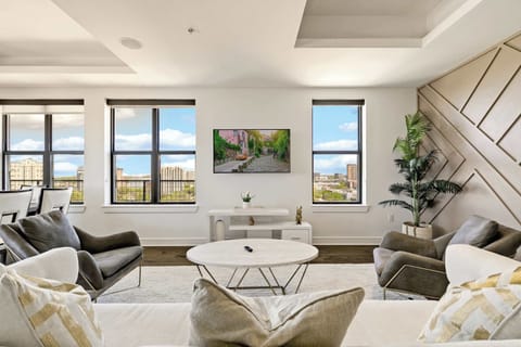 Bright designer living room with breathtaking skyline views and abundant natural light.