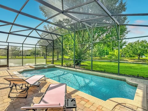 Private screened pool & spa overlooking the lake. Lounge in the Florida sun - no rear neighbors.