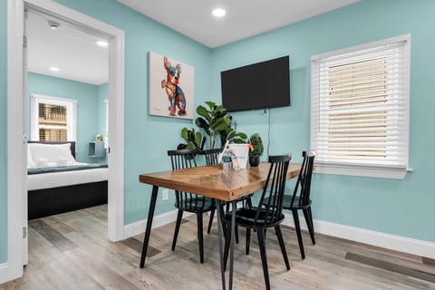 Bright dining nook with seating for 4, TV, and cheerful modern style